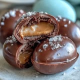 Creamy peanut butter centers dipped in rich dark chocolate and topped with flaky sea salt for a sweet-salty delight.