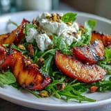 Grilled peach and burrata salad with peachy char and creamy cheese.