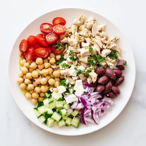 A vibrant Mediterranean Chickpea Chicken Salad with juicy chicken, creamy feta, and crisp cucumbers, tossed in a zesty lemon-herb dressing.