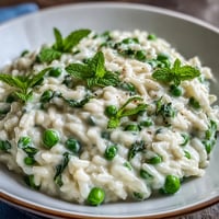 A creamy spring pea and mint risotto with Parmesan, perfect for a light vegetarian dinner or elegant lunch.
