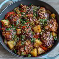 Sticky Honey Garlic Chicken Pineapple Skillet with tender chicken thighs, sweet pineapple, and bell peppers in a savory honey garlic glaze.